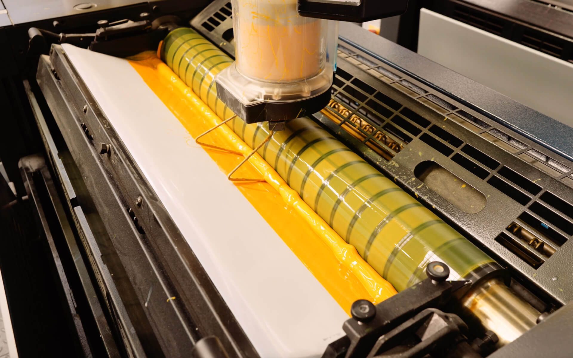 Yellow ink being loaded to a Litho Press